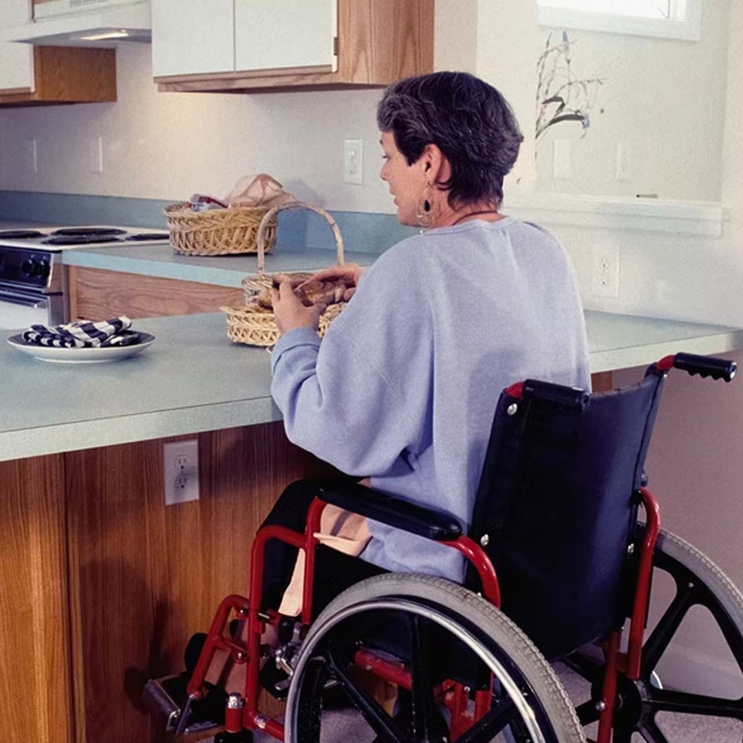 Woman in a wheelchair sitting at a counter